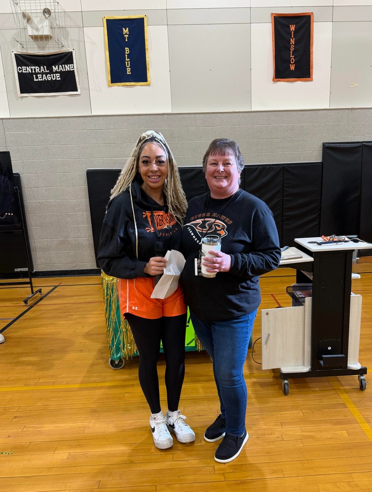 Teacher receiving award in gym