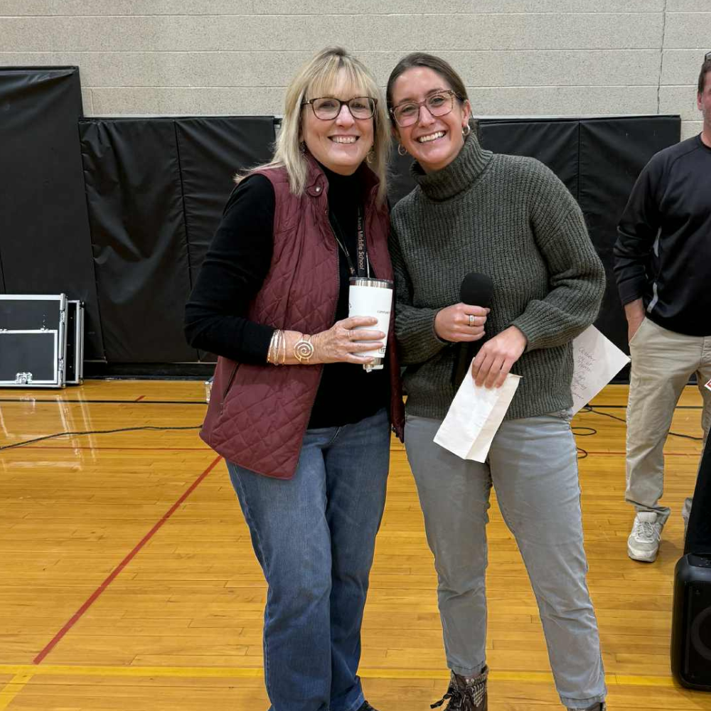 Teacher receiving award in gym