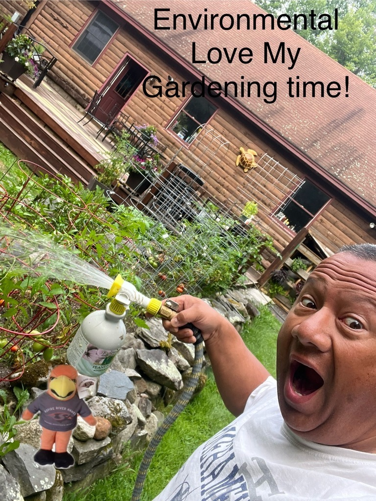Teacher watering plants. Caption: Environmental Love My Gardening Time!