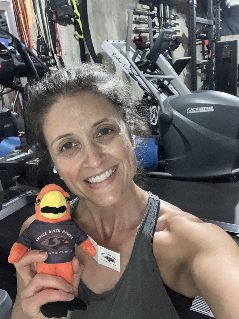Teacher with River Hawk Plushie at the gym