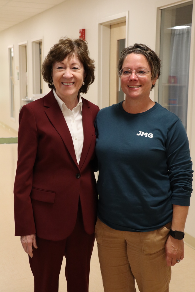 Senator and teacher in school hallway