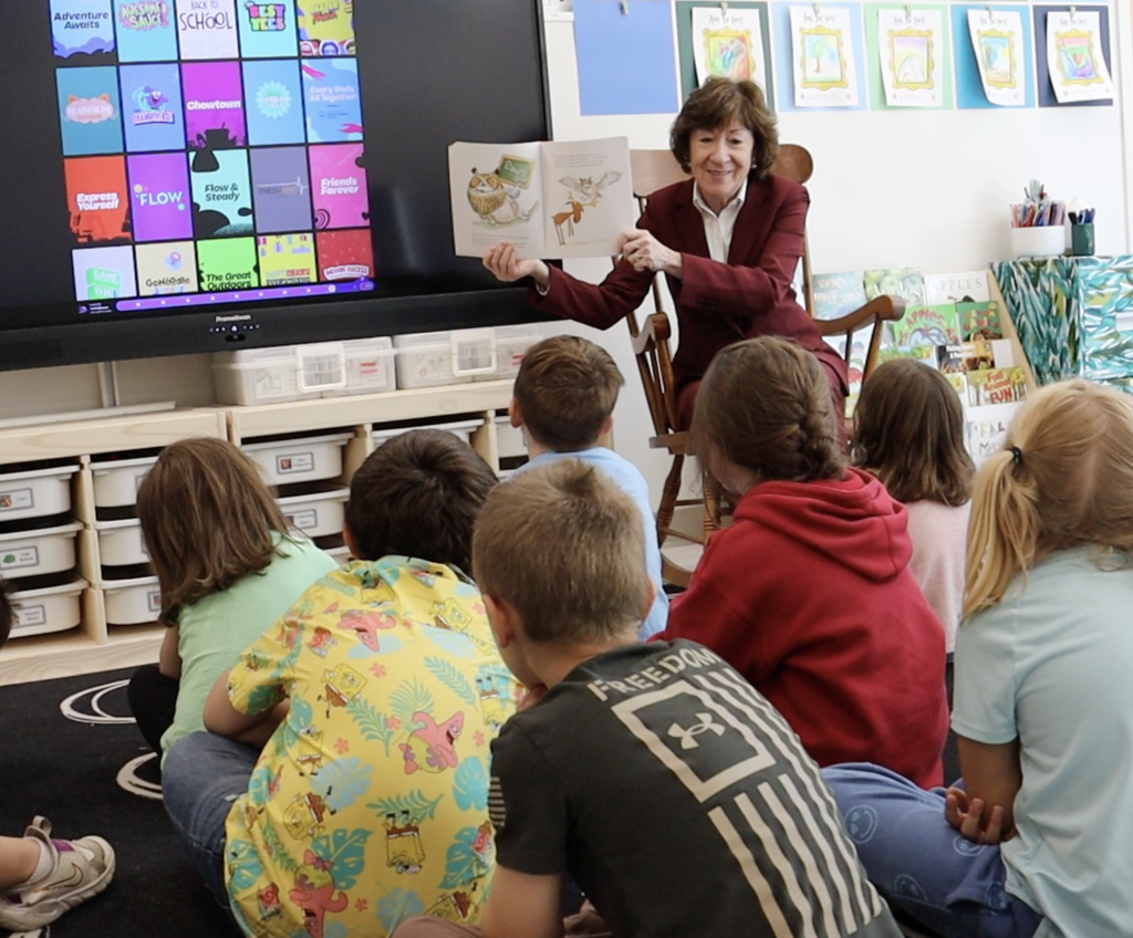 Senator reading to students in classroom