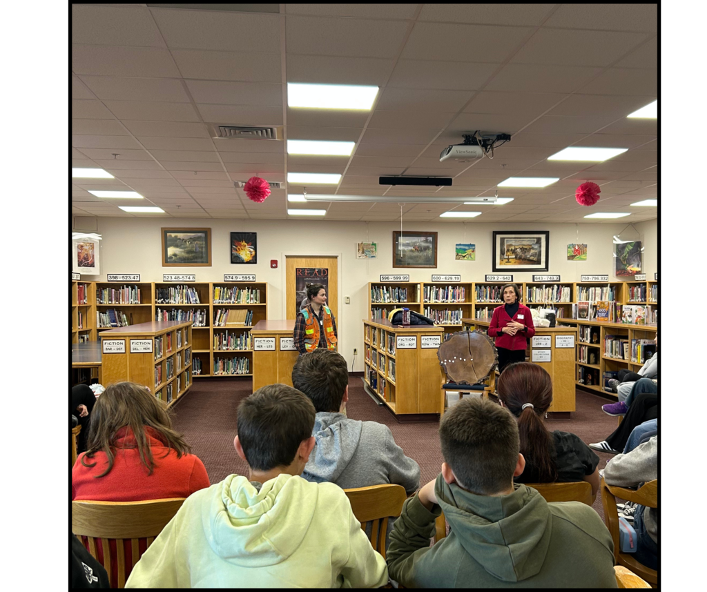 students in library listening to guest speakers