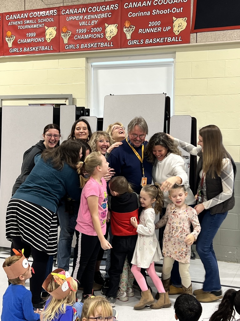 students and teachers gathered around custodian in cafeteria