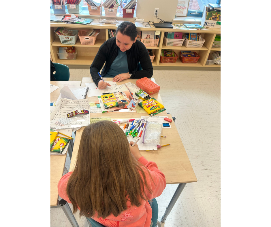 students coloring at desks in classroom