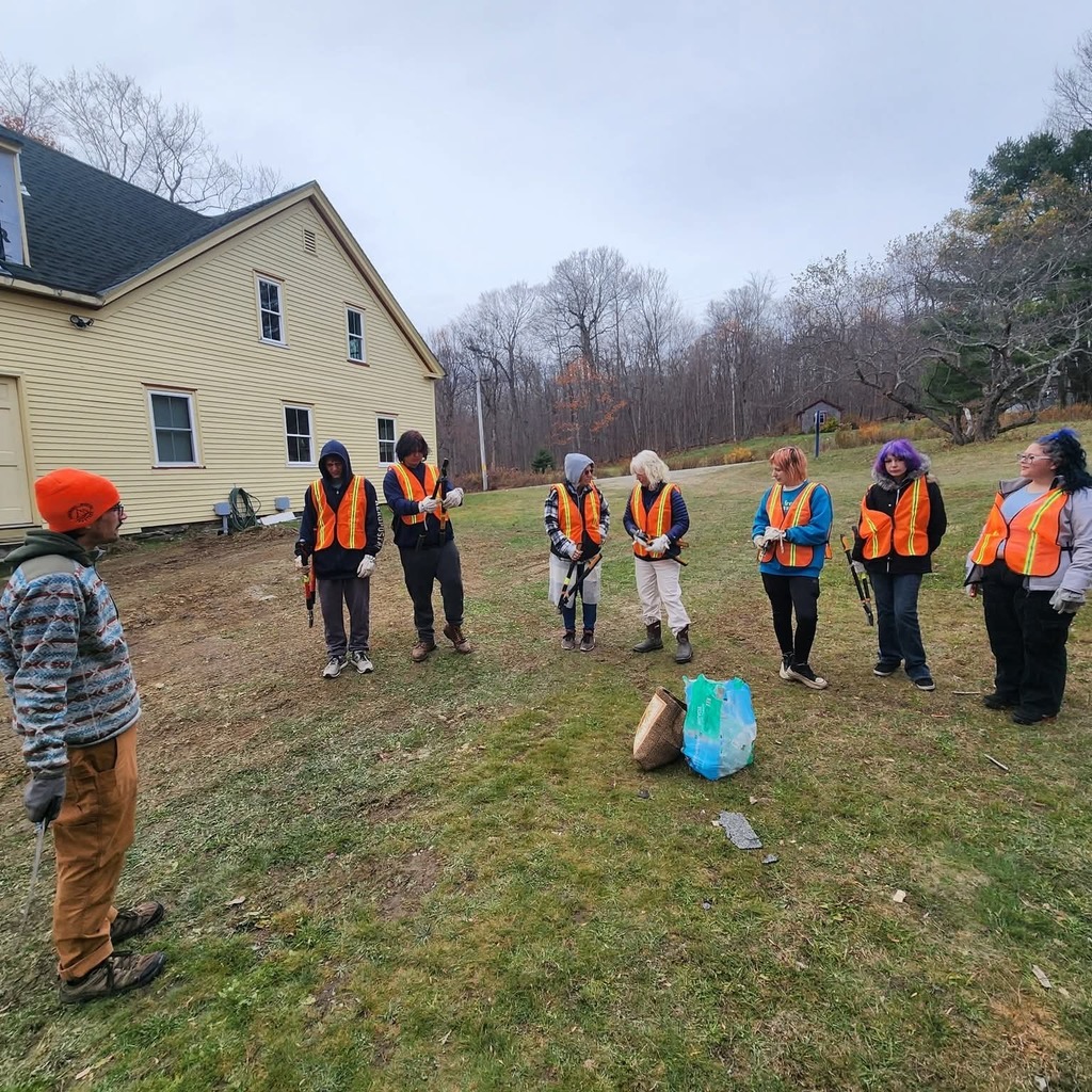 Students outside of the trail head in solon ready to clear brush in orange vests