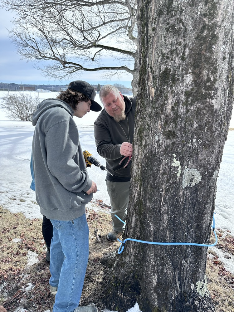 students learning how to properly drill a tap hole