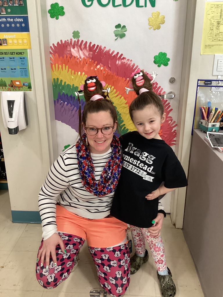 A teacher and a girl in mismatched clothes and crazy hair.