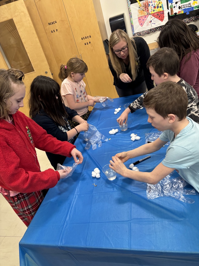 Young children work with cotton balls, water and plastic gloves. 