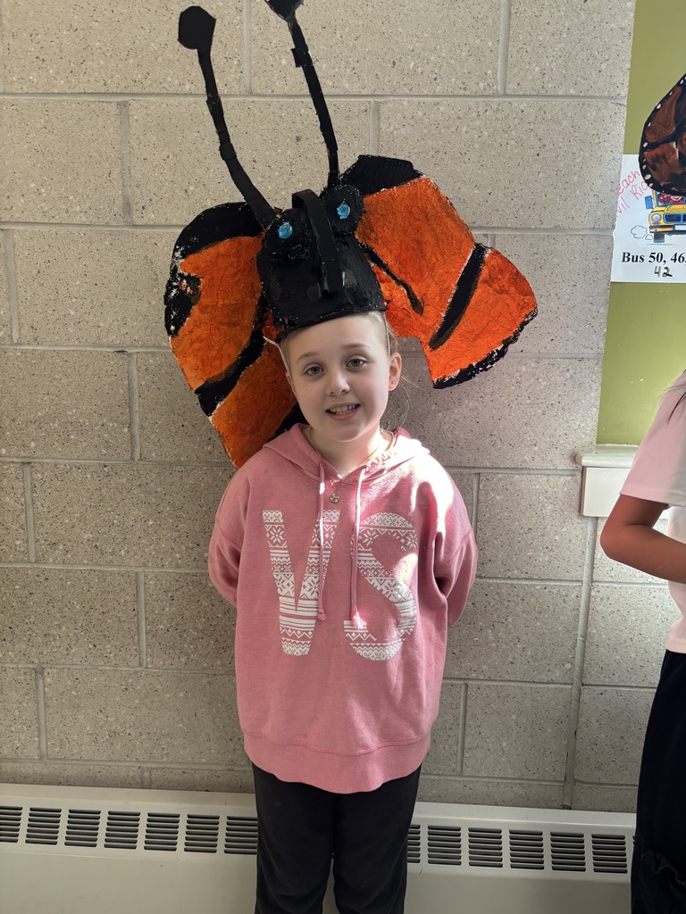 Student wears hat that looks like a monarch butterfly. 