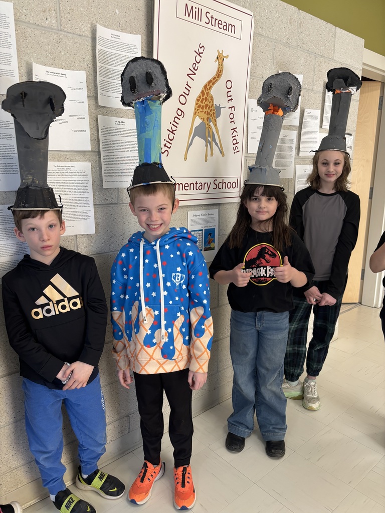 Students wear ostrich headdresses.