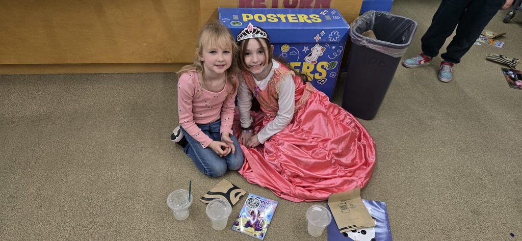 Two girls sitting on the floor.