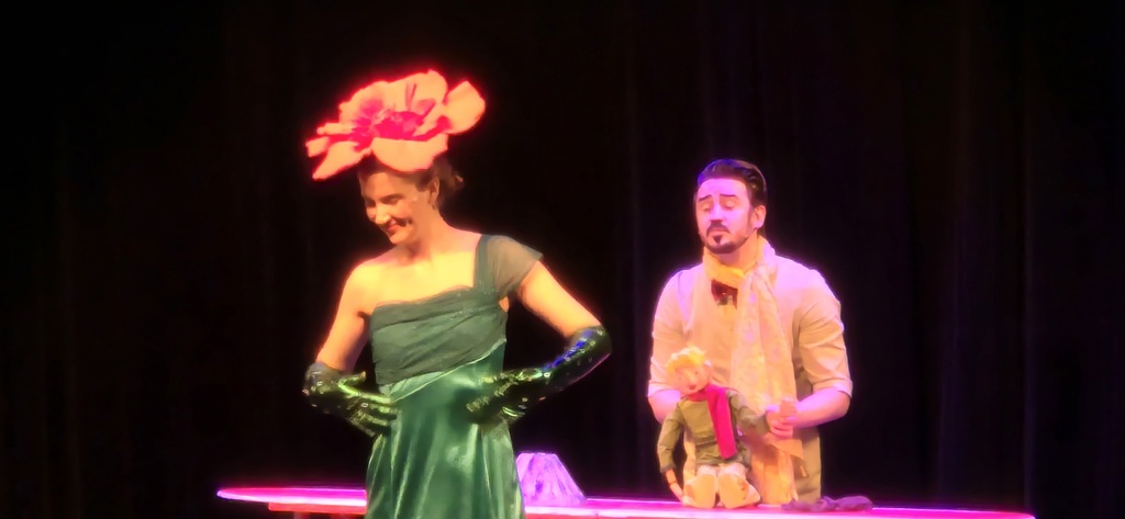 A woman looks away from a man while acting on stage.