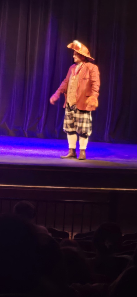 A woman stands on the stage.