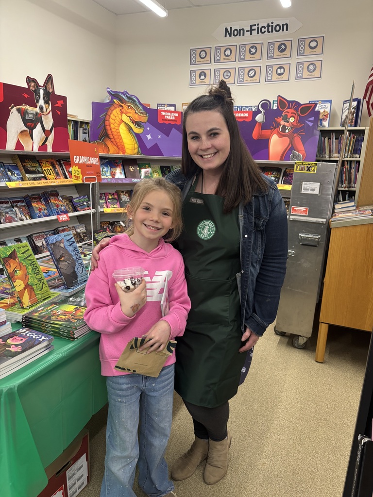 A woman and a girl stand in a book fair.
