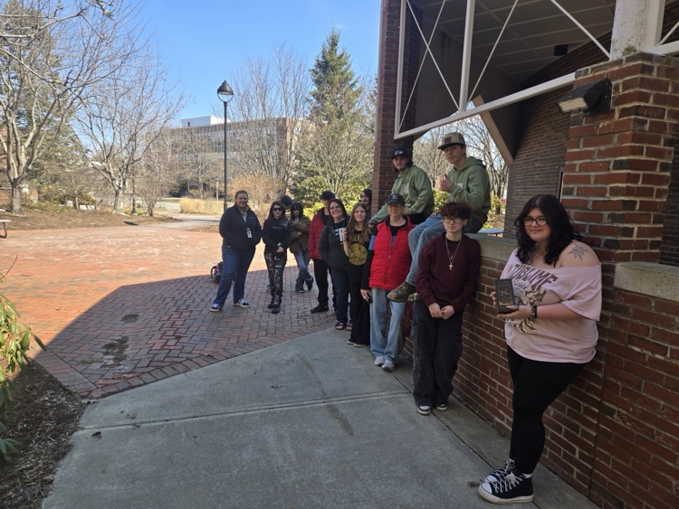 students against a brick wall on campus at umo
