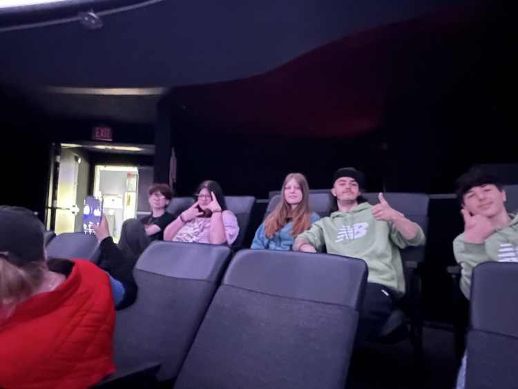 4 students with thumbs up inside the planetarium