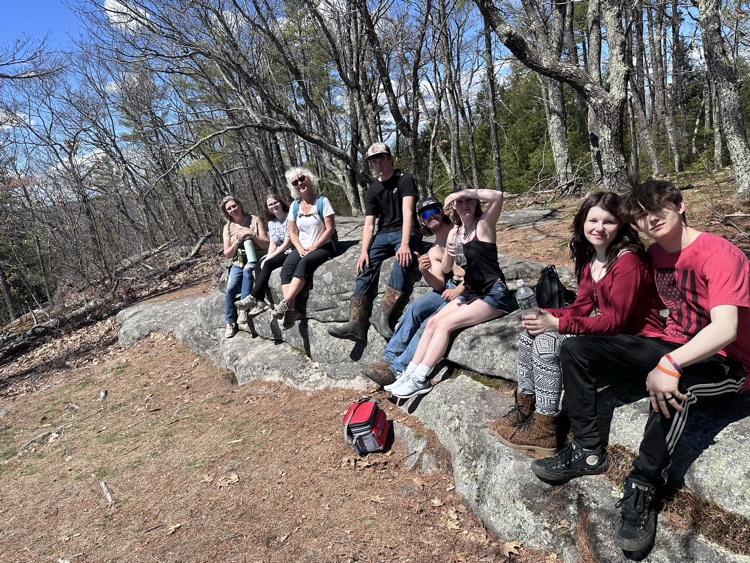 group of students and staff on top of the mountain