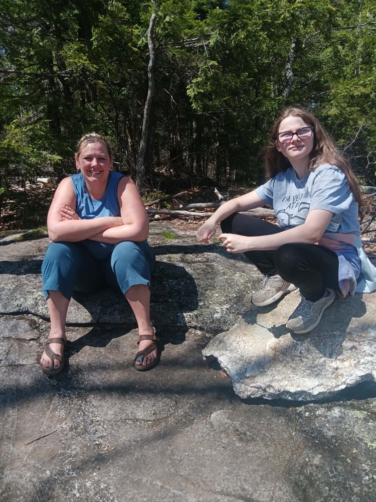 staff and student in top of the mountain