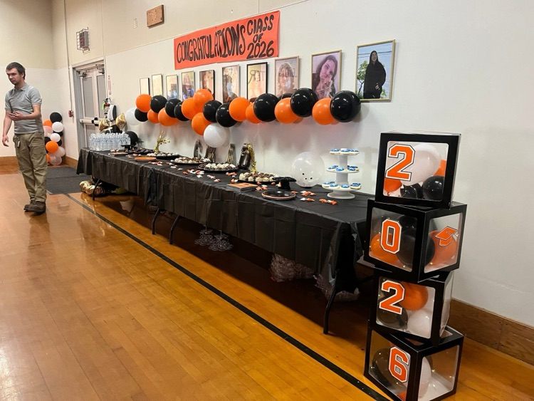 picture of the wall of graduates and food table