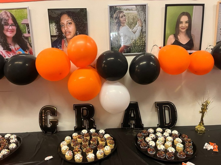 zoomed in photo of wall of grads and food table