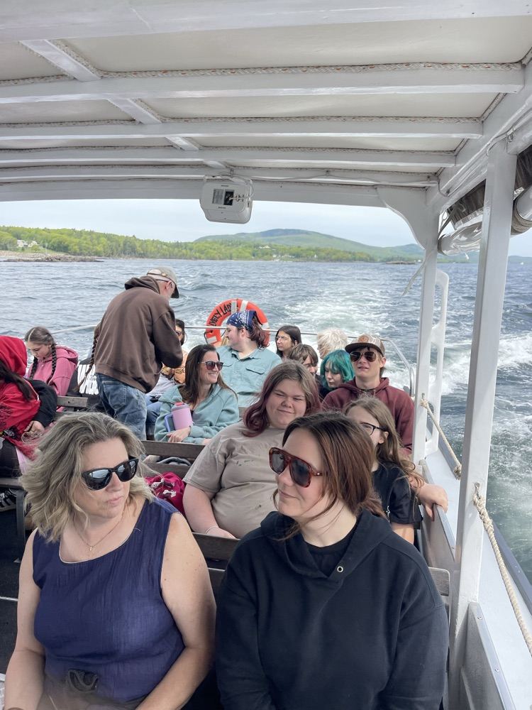 students and staff on lobster boat
