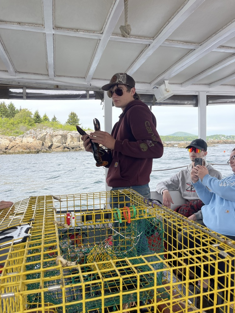 student getting ready to throw a lobster back