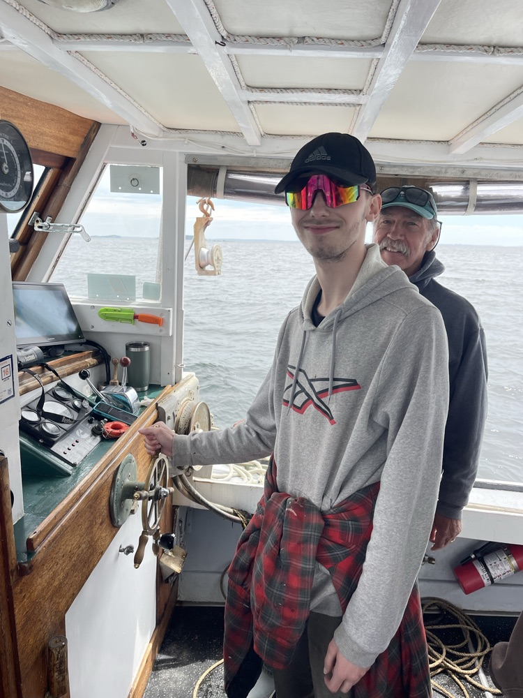 student driving the boat