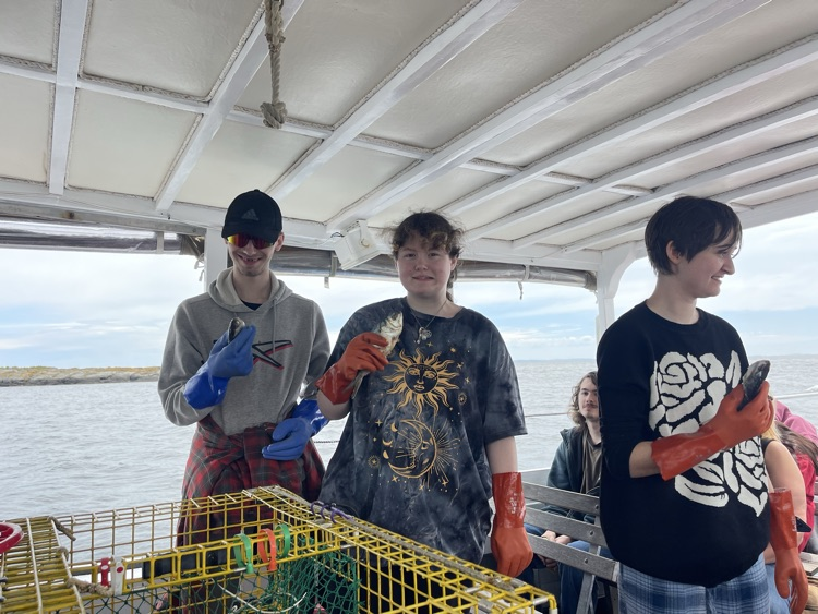 students baiting a lobster trap