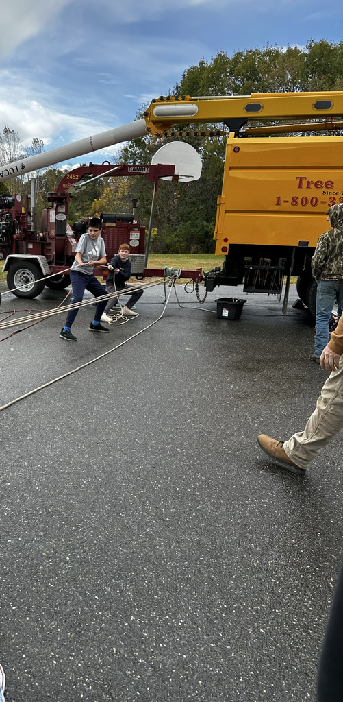 a student testing his pull strength at the Lucas Tree station during field day