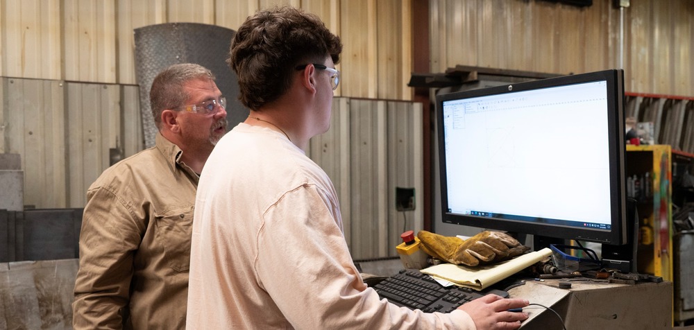 two people on a computer
