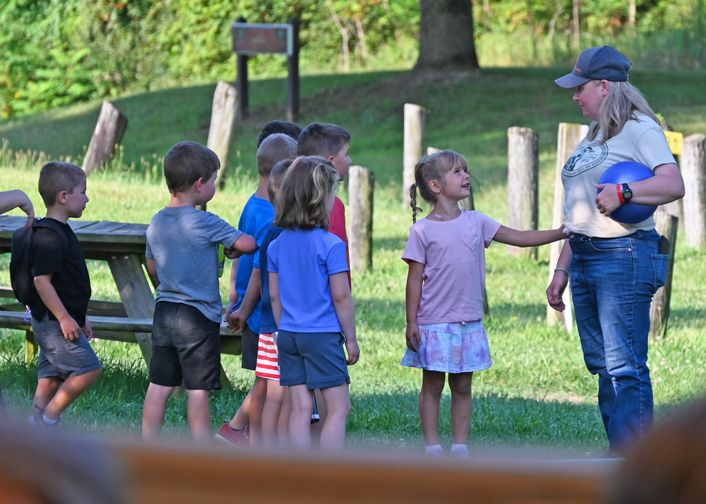 kids in group with one looking up at adult