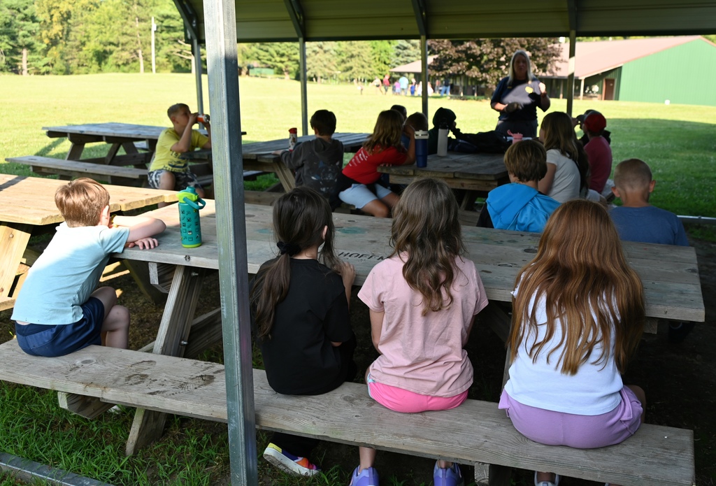 kids sitting at picnic tables