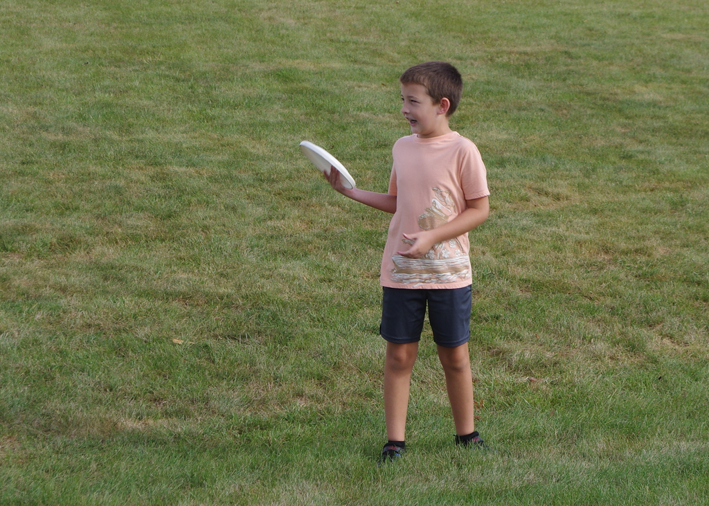 boy holding frisbee