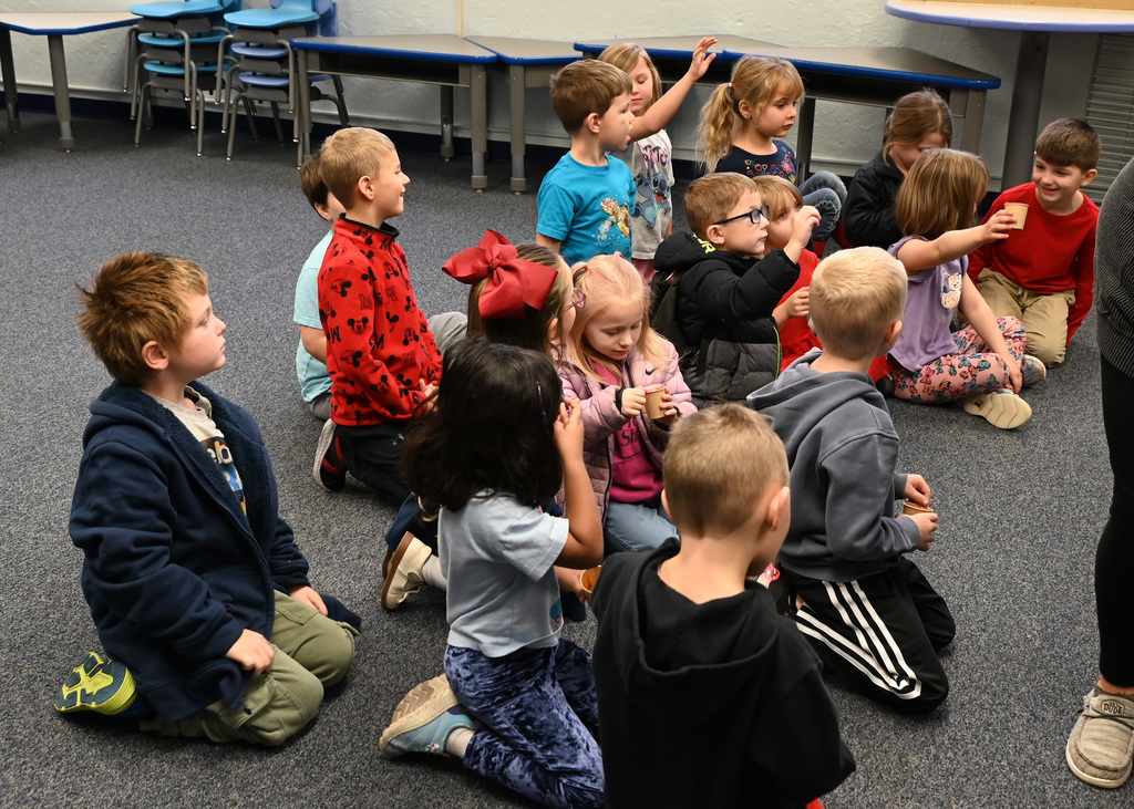 childern sitting in group on floor