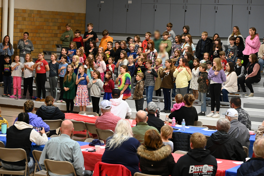 students stankding singing in a gym