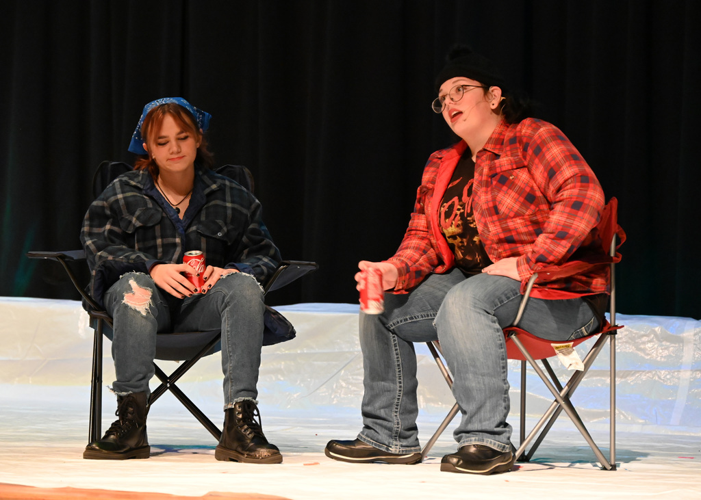 two people on camp chairs talking