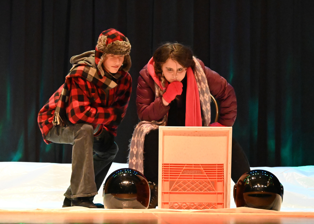 man and woman bending down looking at photo