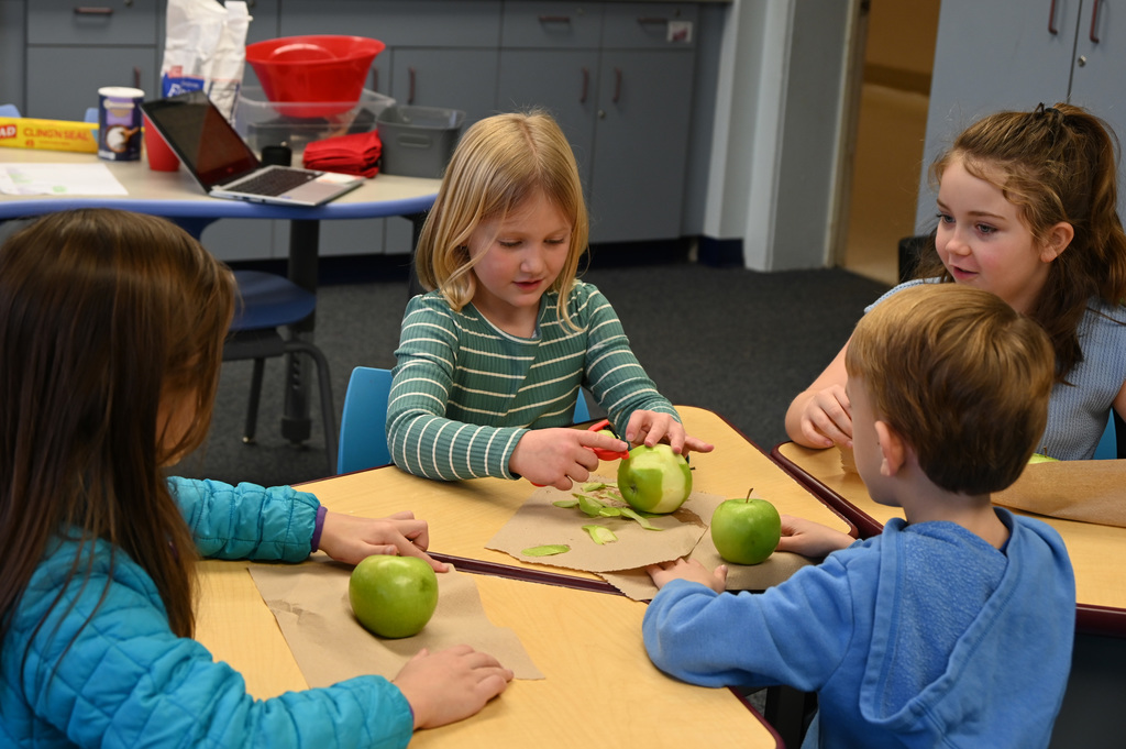 4 childerm pealing apples