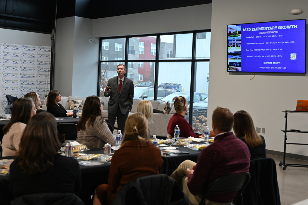 person talking to a group of people