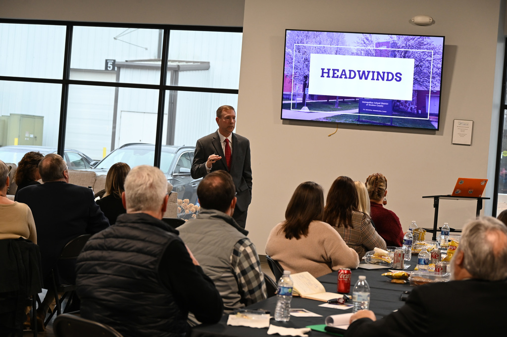 person talking to a group of people