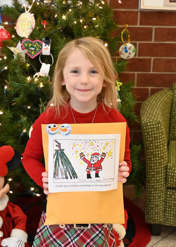 girl holding envelope with card she designes