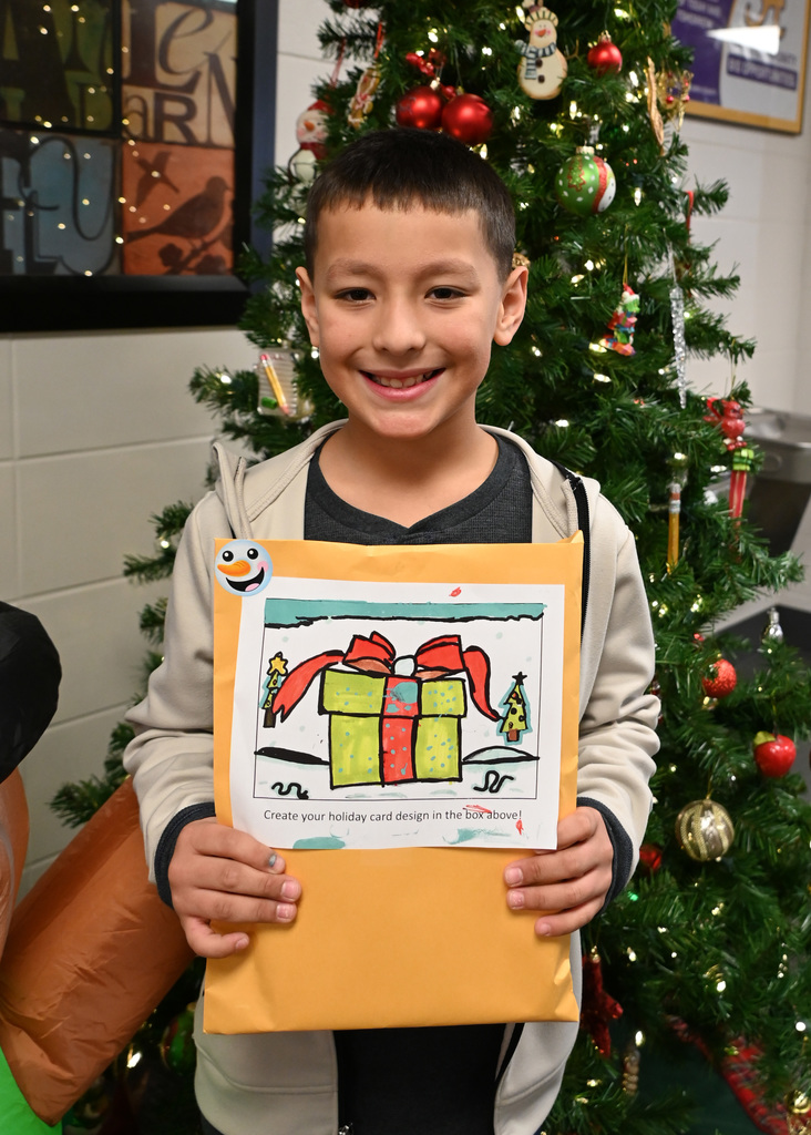 child holding envelope with card they designed