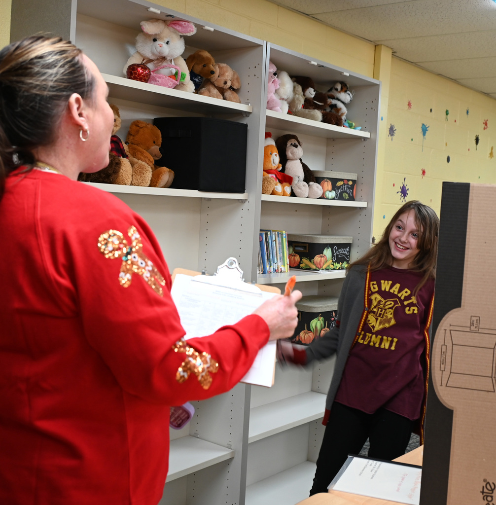 student in front of judge presenting science fair project