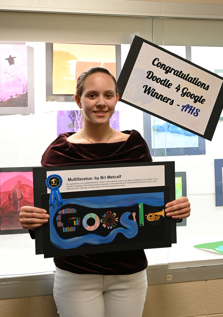 Student holding poster of her artwork