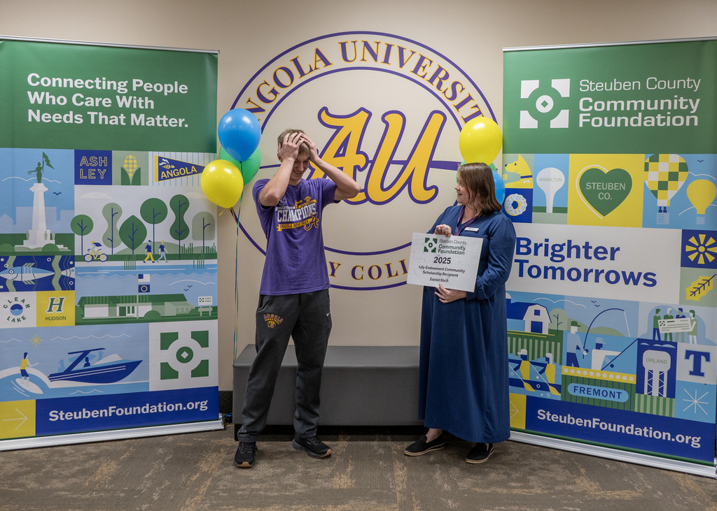 male holding head in suprise bieng presented sign by femail