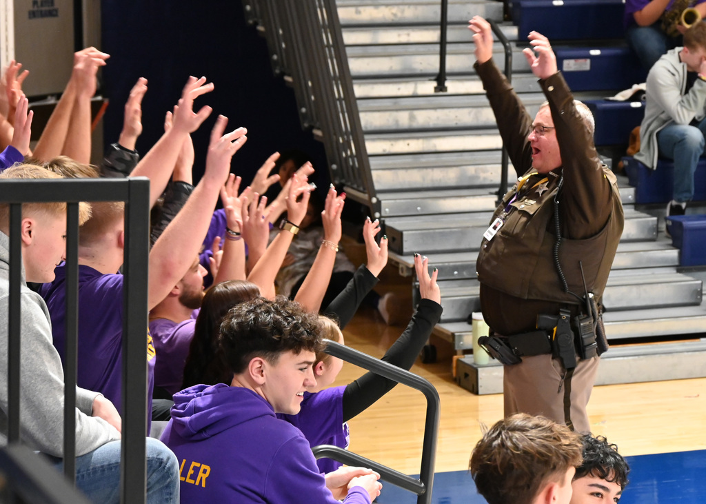officer leading chant to fans