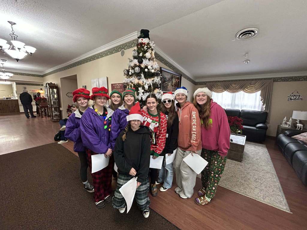 girls in front of christmas tree