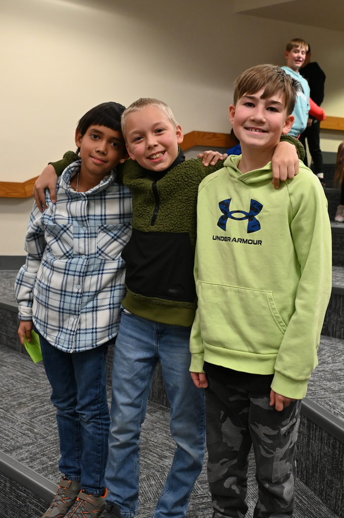 three boys with arms around each other