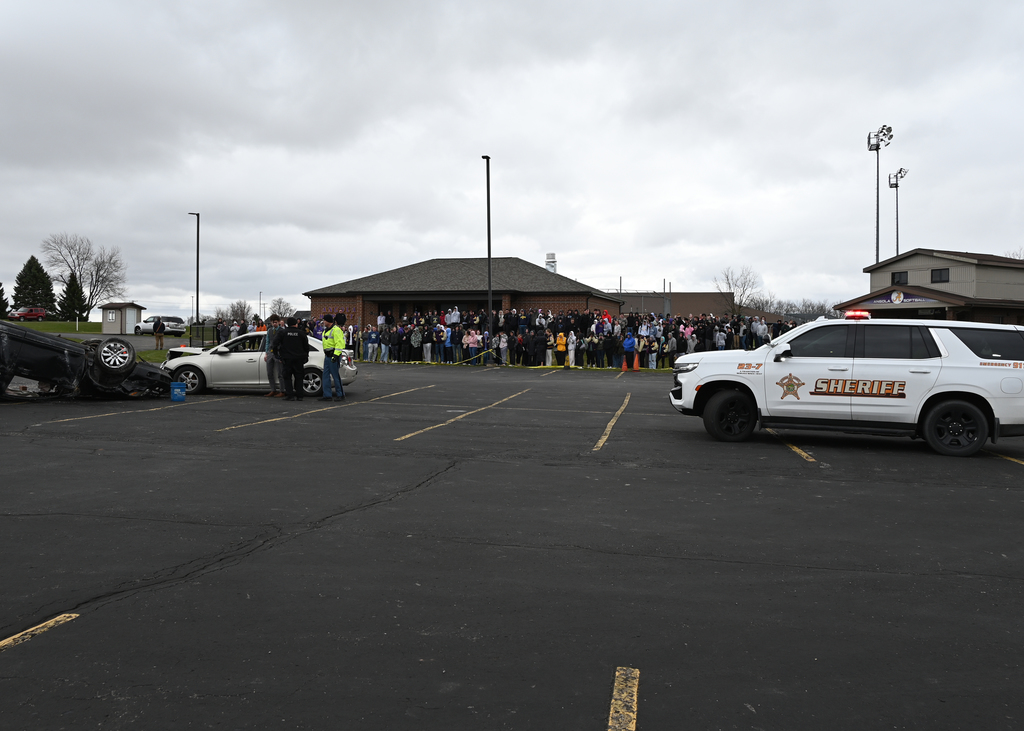 mock crash in front of large group of students